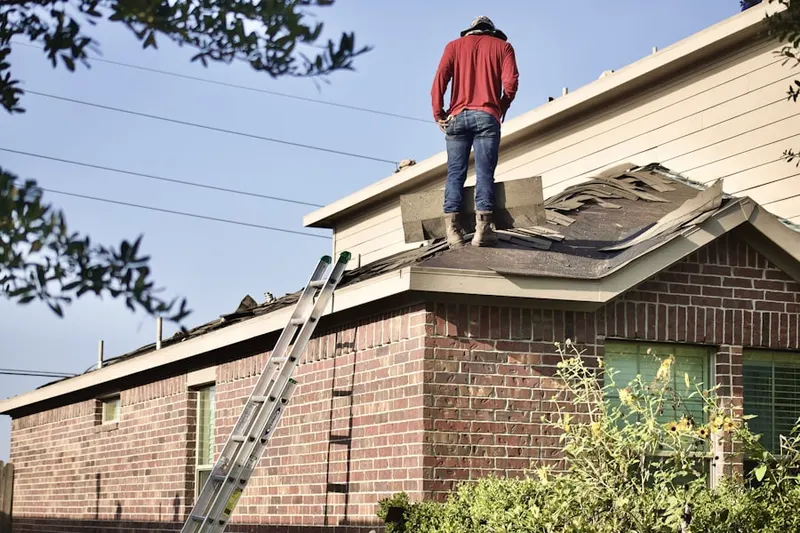 Professional roofer working on a residential roof in Alta High